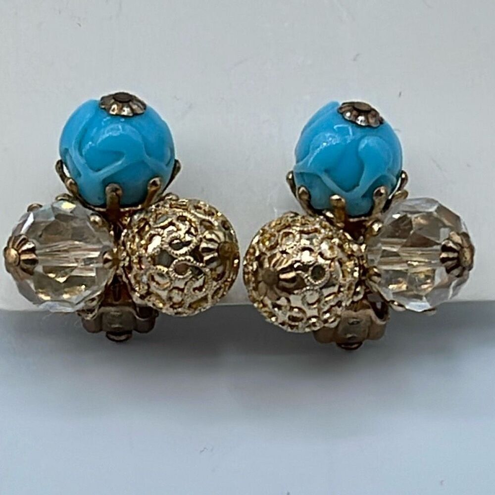 Vintage Vogue ornate clip on earrings. Ab and blue glass .